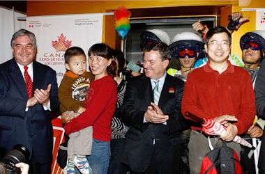 The Honourable Peter Van Loan, Minister of International Trade, and the Honourable James M. Flaherty, Minister of Finance, welcome the family of Qiao Ren Biao, the one-millionth visitor to the Canada Pavilion, Expo 2010 Shanghai.