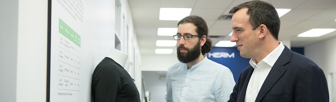 Two company directors looking at a poster