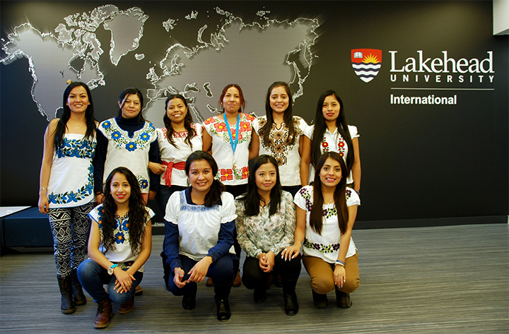 A group of students and their professor in a research center.