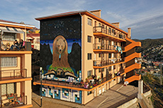 •	A mural on the side of an apartment complex in Chile