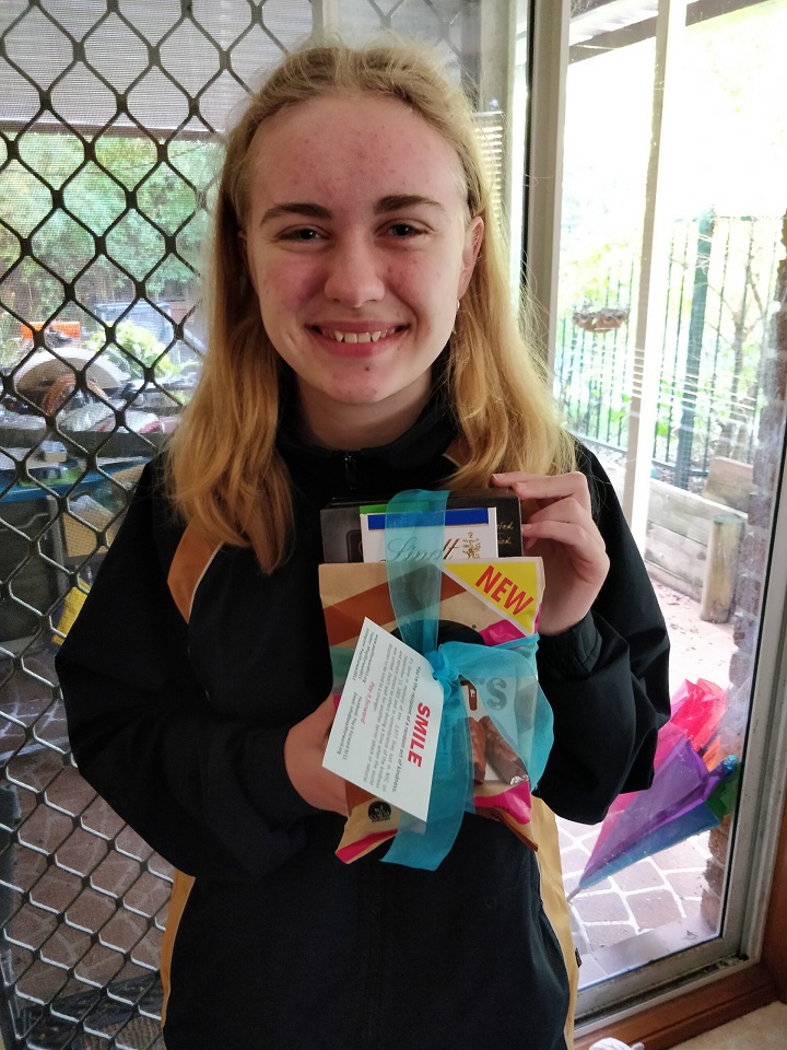 Young girl holds a care package she created