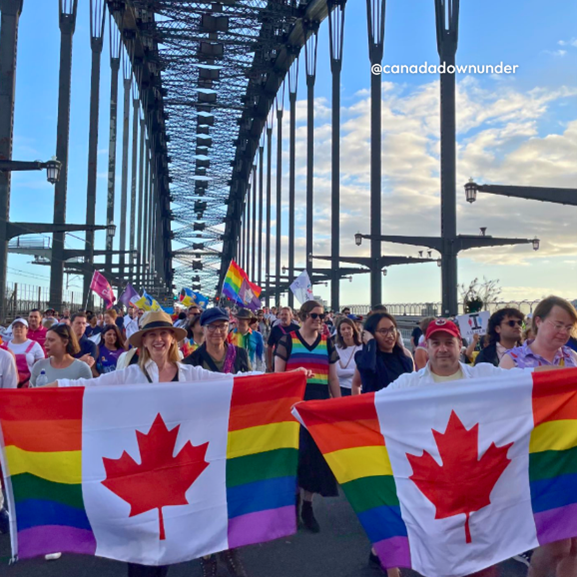 Canadian embassy staff are celebrating Pride season in Brazil. Employees are dressed in bright colours and are holding a rainbow Canada flag at the Pride parade in São Paulo. 