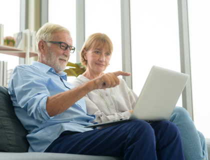 An elderly couple looking at information on a computer